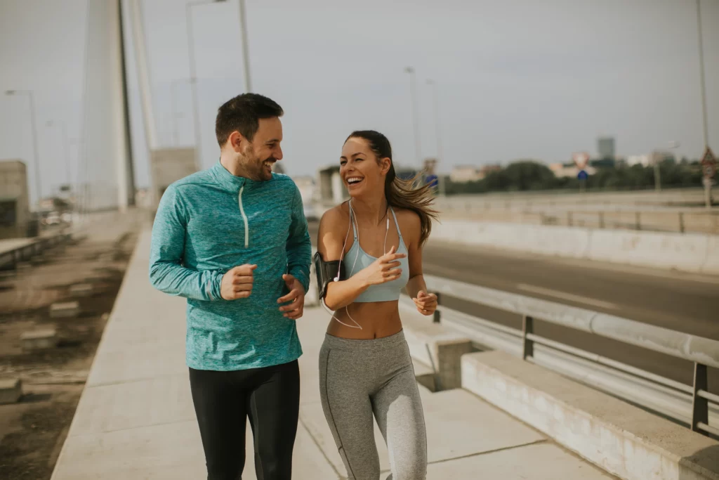 Couple stretching together on a park path
