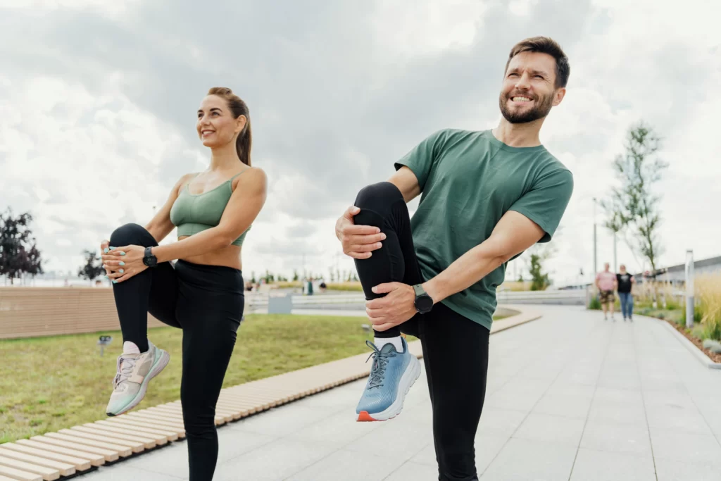 Couple stretching together outdoors